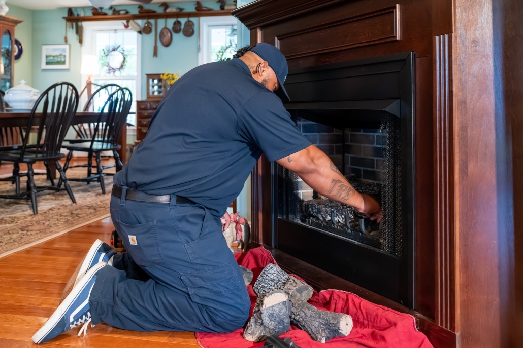 Burch technician working on a fireplace.