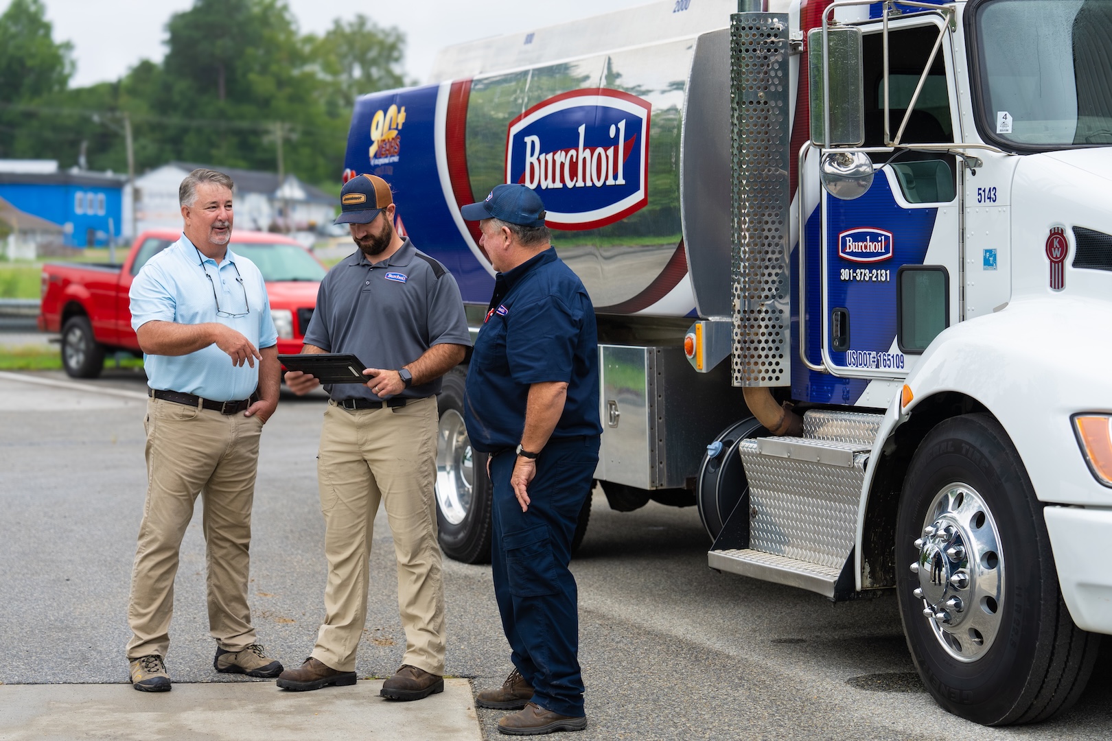 Burch diesel truck with three men standing in front