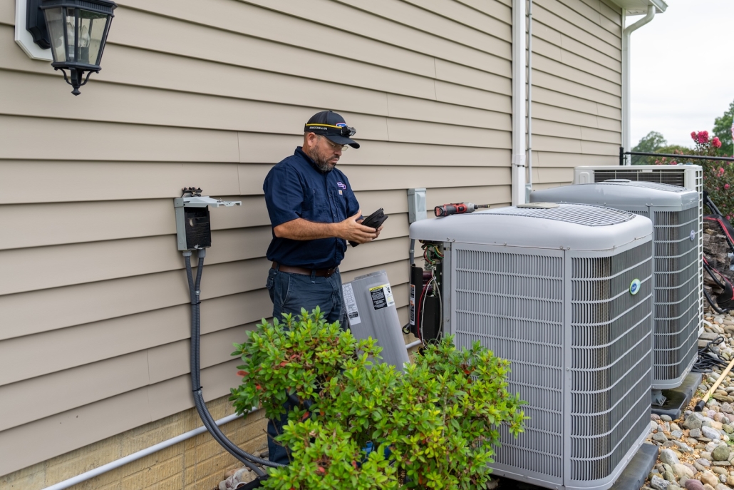 Burch technician working on a heat pump.