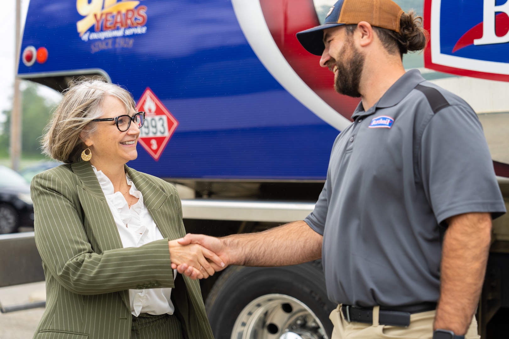 Burch technician shaking hands with a customer