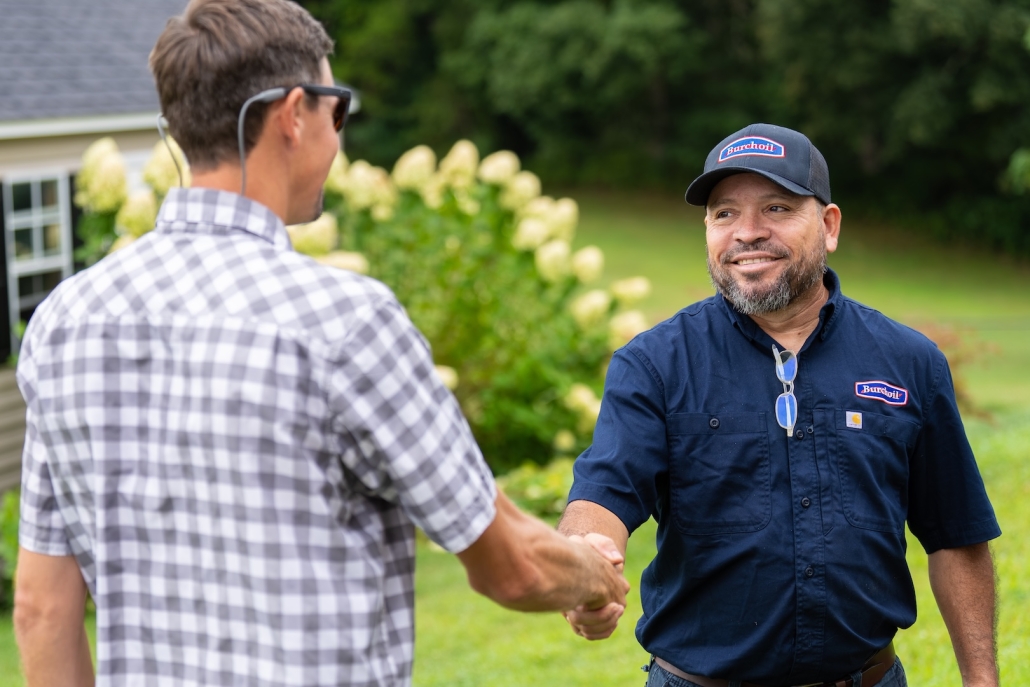 Burch technician shaking hands with customer after discussing their HVAC, propane and heating oil needs.