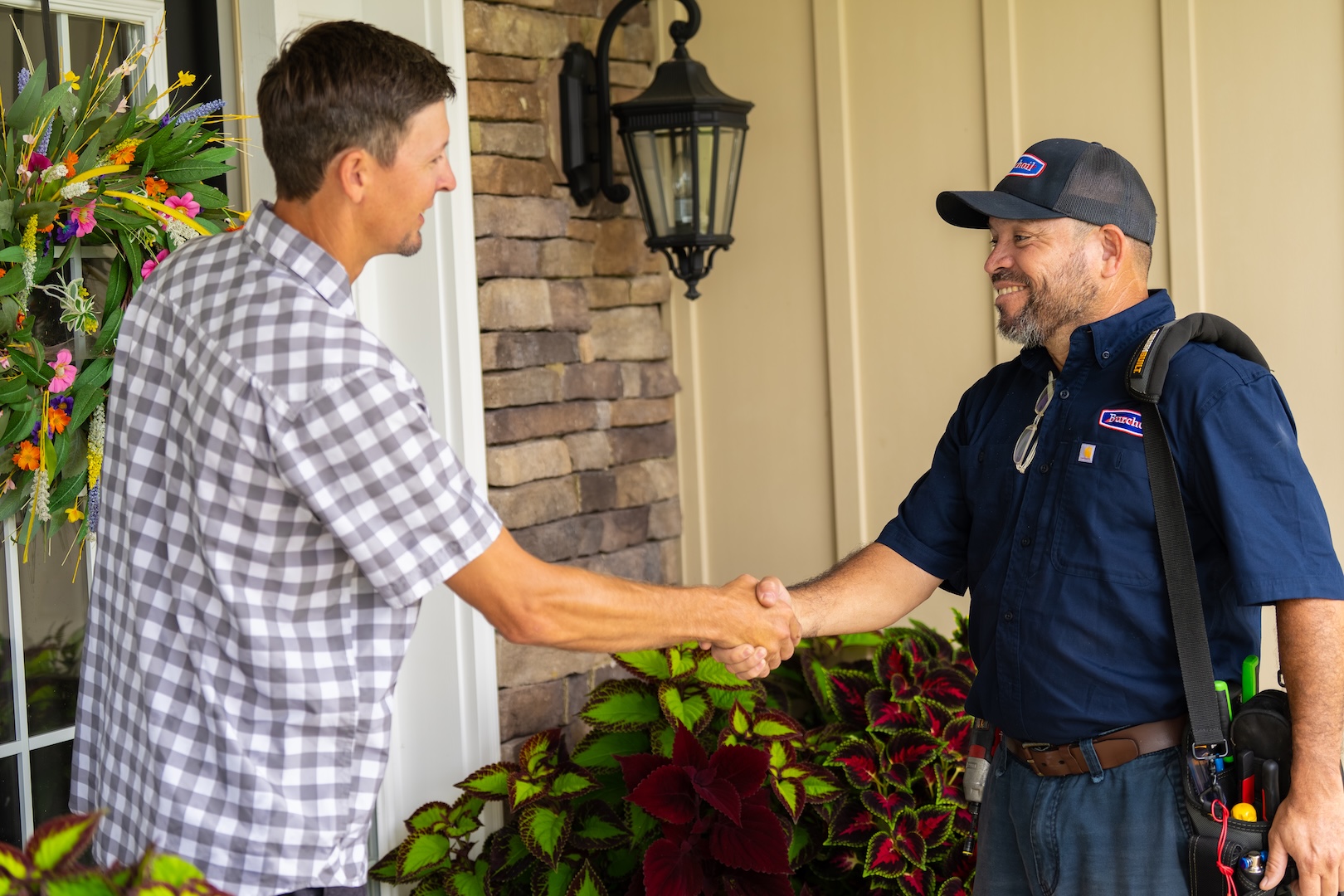 Burch technician shaking hands with customer after discussing their HVAC, propane and heating oil needs.