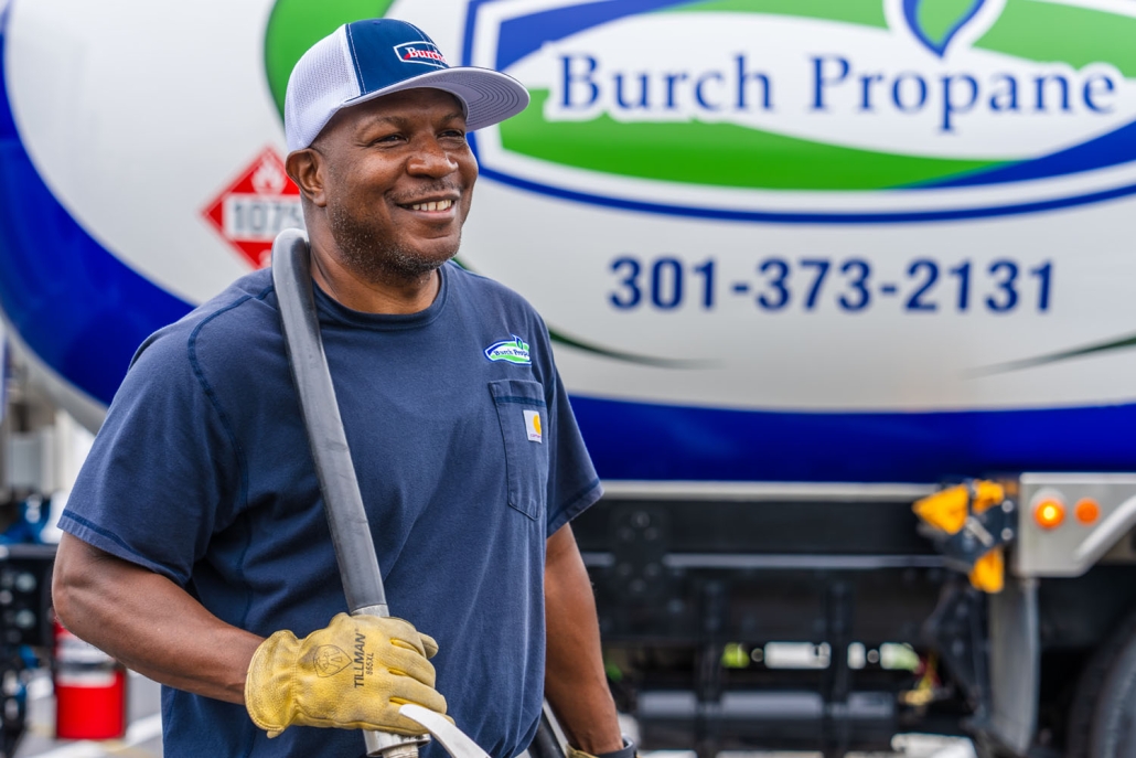 Burch worker smiling with propane hose