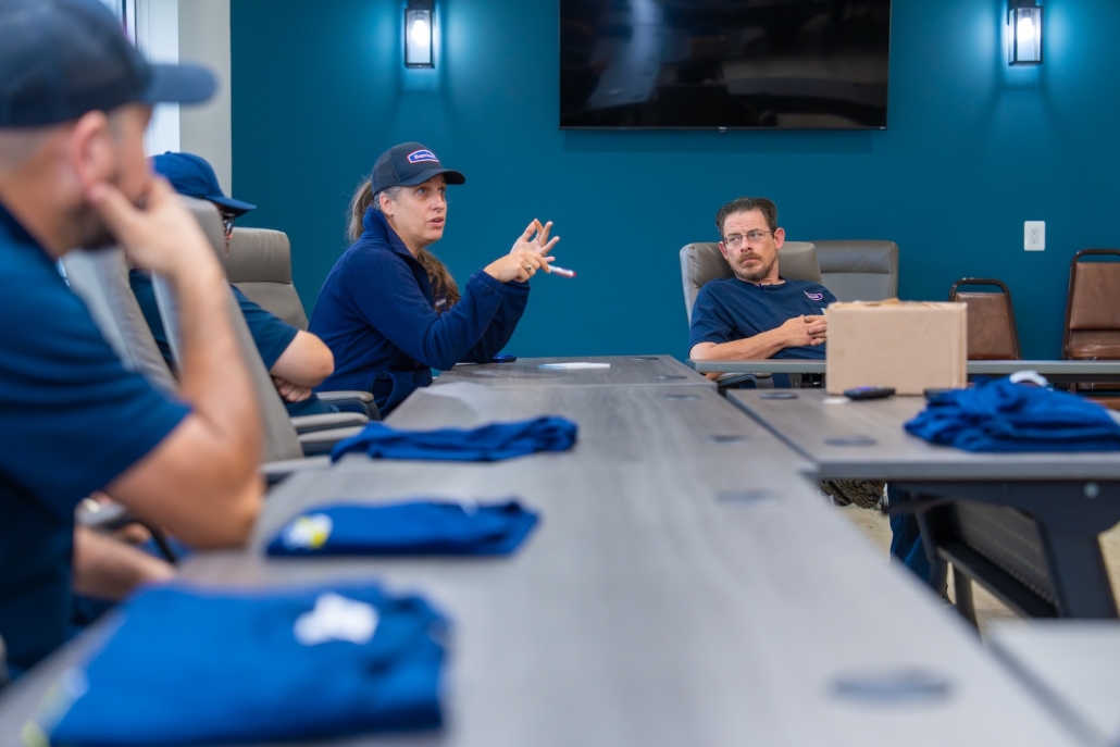 Burch employees in matching uniforms at a conference table