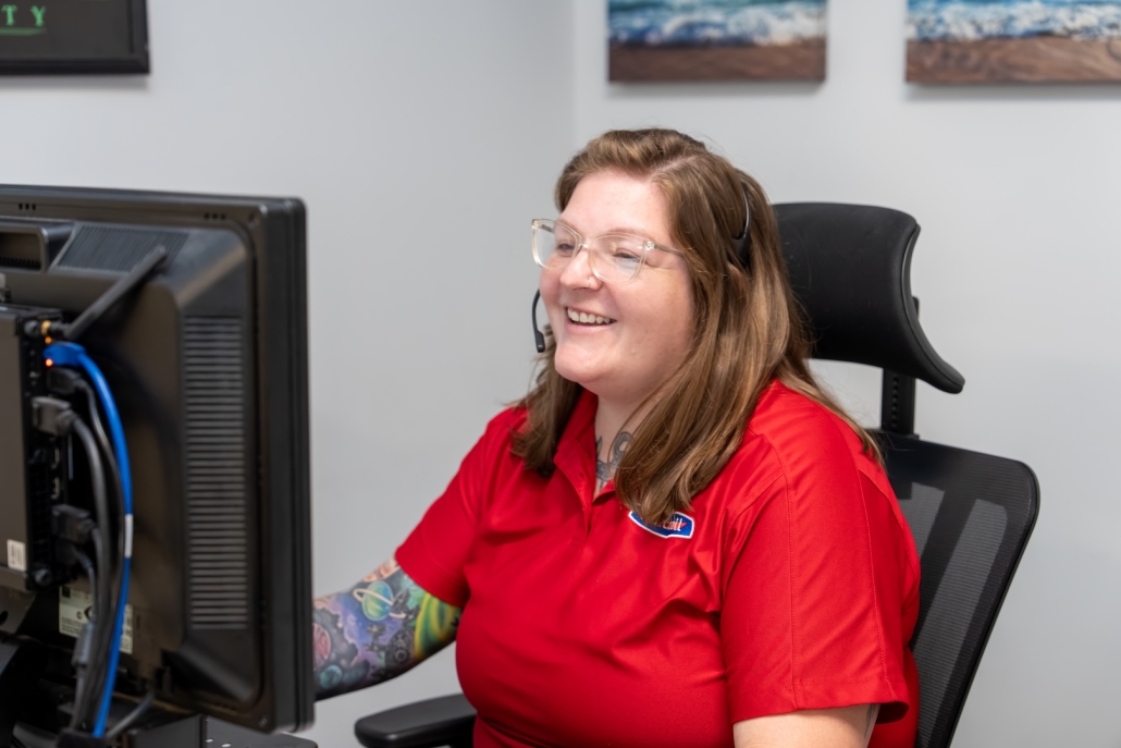 Burch employee talking on headset in front of computer
