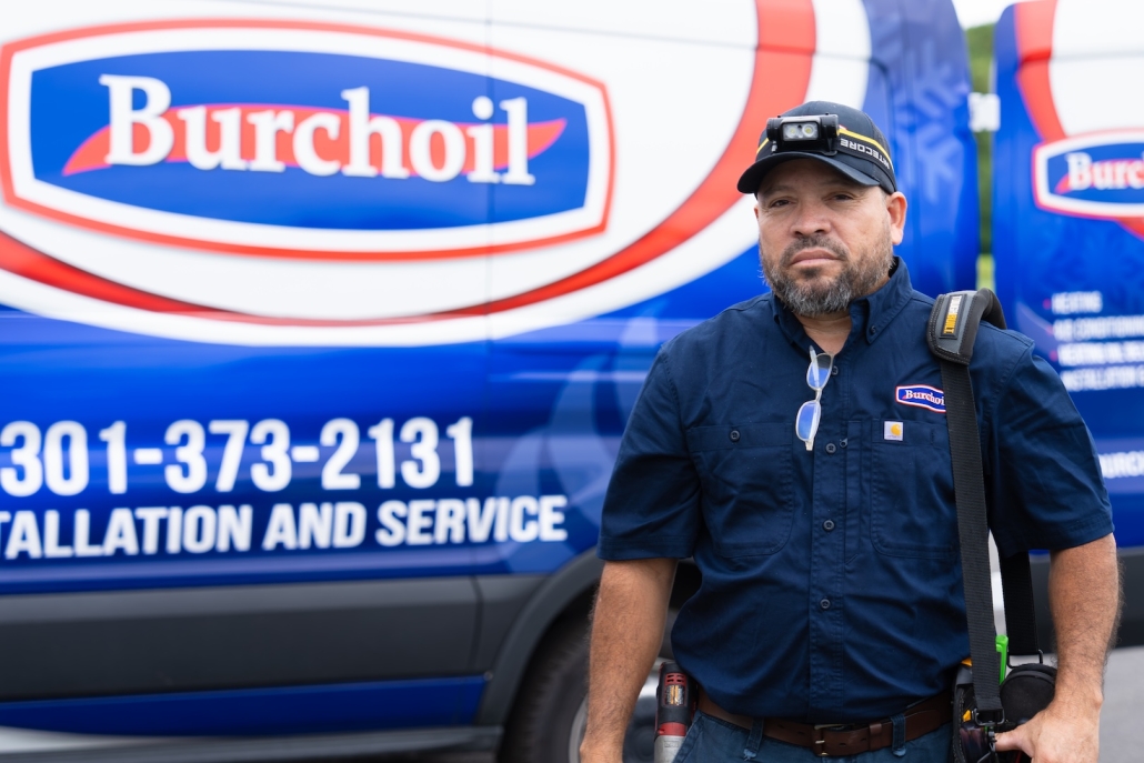 Burch worker in front of work van carrying tools