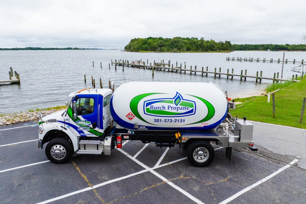 Burch propane truck in a parking lot next to a lake with docks